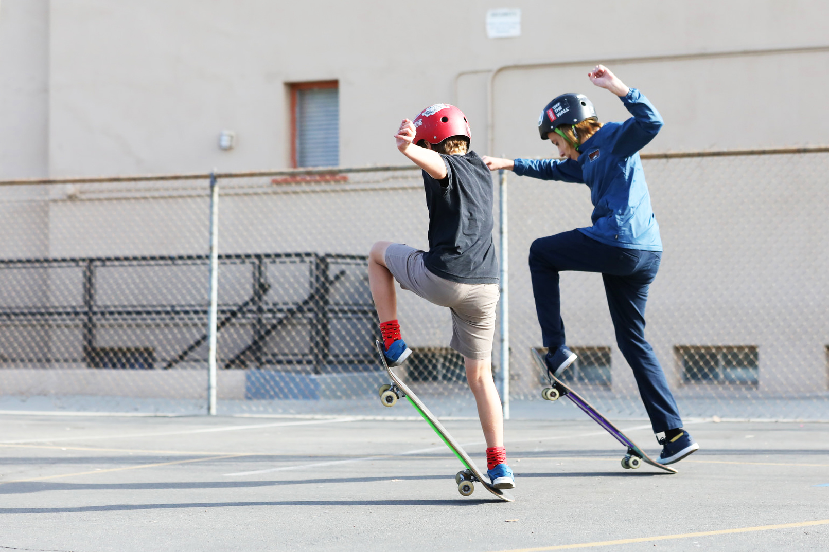 Two homeschooled boys from Compass Charter Schools on skateboards doing an ollie