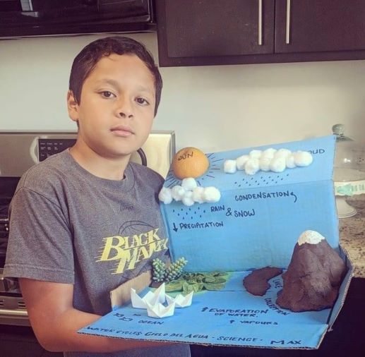 A Compass Online scholar displays their hydrologic cycle model for geography class, which displays the cycle of water through precipitation.