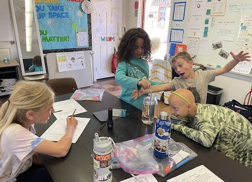 Compass Charter School students work together around a table