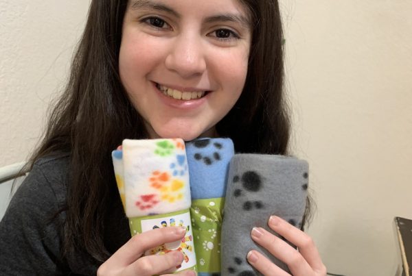 Emma Anne Rodriguez of Compass Charter Schools displays the cat toys she made for the Humane Society in a virtual workshop.