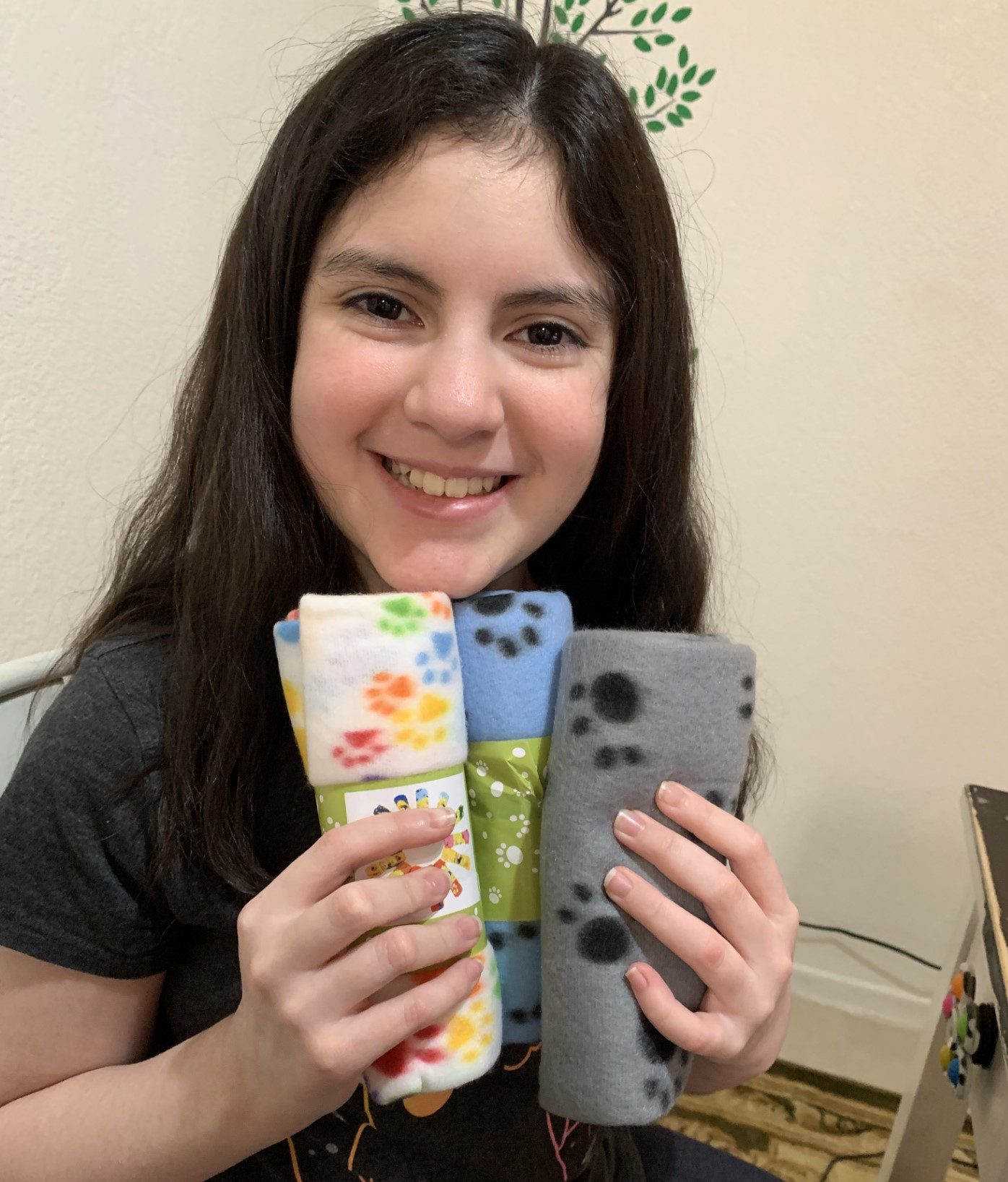 Emma Anne Rodriguez of Compass Charter Schools displays the cat toys she made for the Humane Society in a virtual workshop.