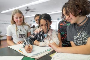 Compass Orange County Learning Center scholars collaborate on a project.